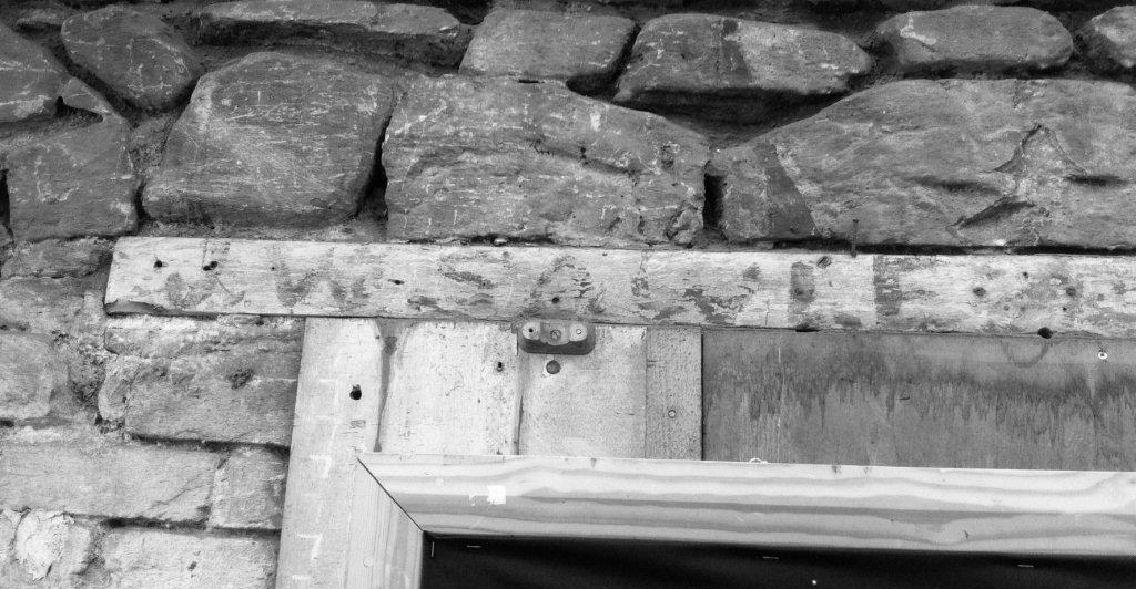 J W Sawle written on the lintel above the door of the blacksmiths shop in Stanley, Falkland Islands