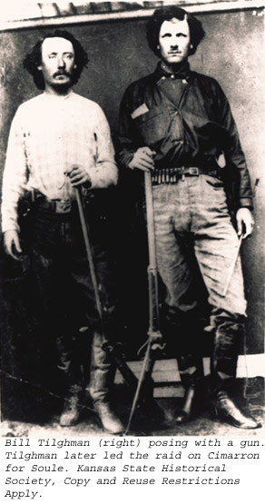 Bill Tilghman (right) posing with a gun